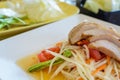 Thai papaya salad on white dish with grilled pork Royalty Free Stock Photo
