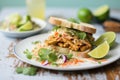 thai peanut tempeh sandwich with coleslaw and lime wedge