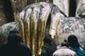 Thai peaple touch Hand of Buddha Statue at Srichum Temple, historical park at Sukhothai thailand.