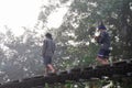 Thai people carrying firewood walking on Suspension wooden bridge Royalty Free Stock Photo