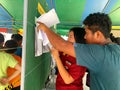 Thai people checking their names on the board to elect the new government after 6 years long coup on pre-election day on March 17