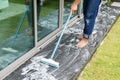 Thai people cleaning black granite floor with brush and chemical