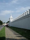 Thai people dress in black walk along the palace wall to join the Royal ceremony