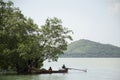 Thai people fisherman stop wooden fishing boat under tree on the Royalty Free Stock Photo