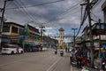 Thai people and foreign travelers drive car and ride motorcycle and bike bicycle at traffic road Clock bell tower roundabout of