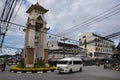 Thai people and foreign travelers drive car and ride motorcycle and bike bicycle at traffic road Clock bell tower roundabout of