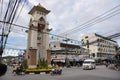 Thai people and foreign travelers drive car and ride motorcycle and bike bicycle at traffic road Clock bell tower roundabout of