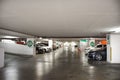 Thai people and foreign travelers drive vehicle to stop in car parking underground building for travel relax and shopping at