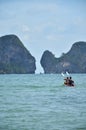 Thai people and foreign travelers rowing canoe kayak in sea for relax travel visit limestone isle mountain in ocean of andaman