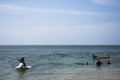 Thai people and foreign travelers travel visit play swimming wave water in sea and ride playing jetski banana boat in ocean of Royalty Free Stock Photo