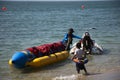 Thai people and foreign travelers travel visit play swimming wave water in sea and ride playing jetski banana boat in ocean of Royalty Free Stock Photo