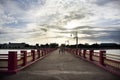 Thai people and foreign travelers travel visit rest relax and exercise playing sport on Saphan saranwithi red bridge sunset at Royalty Free Stock Photo