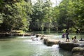 Thai people foreigner travel relax and play swimming in Namtok Chet Sao Noi small waterfall in Saraburi, Thailand