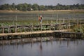 Thai people and foreigner travelers travel and walking visit on Kae Dam long wood bridge at Maha Sarakham, Thailand