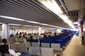 Thai people and foreigner travelers walking and sitting waiting check in inside of Udonthani International Airport in Thailand