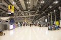 Thai people and foreigner travelers walking and wait at Suvarnabhumi international airport with passengers arriving and departing Royalty Free Stock Photo