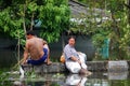 Thai people natural disaster victims stand and wading in water on street of alley while water flood road wait help rescue and