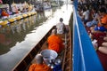 Thai people praying put food and thing offerings to monks procession on boat in tradition of almsgiving at Wat Sai Yai on November Royalty Free Stock Photo