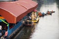 Thai people praying put food and thing offerings to monks procession on boat in tradition of almsgiving at Wat Sai Yai on November Royalty Free Stock Photo