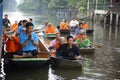 Thai people praying put food and thing offerings to monks procession on boat in tradition of almsgiving at Wat Sai Yai on November Royalty Free Stock Photo