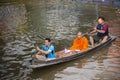 Thai people praying put food and thing offerings to monks procession on boat in tradition of almsgiving at Wat Sai Yai on November Royalty Free Stock Photo