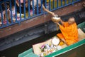 Thai people praying put food and thing offerings to monks procession on boat in tradition of almsgiving at Wat Sai Yai on November Royalty Free Stock Photo