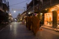 Thai people put food offerings to monks procession walk on the road