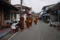 Thai people put food offerings to monks procession walk on the road