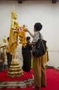 Thai people respect praying and gild cover with gold leaf on Luang Pho Ban Laem Royalty Free Stock Photo