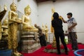 Thai people respect praying and gild cover with gold leaf on Luang Pho Ban Laem Royalty Free Stock Photo