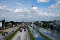 Thai people riding motorcycle and driving car on street while water flood or inundation road with vehicle busy jam traffic highway Royalty Free Stock Photo