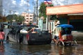 Thai people riding motorcycle and driving car on street while water flood or inundation road with vehicle busy jam traffic highway Royalty Free Stock Photo