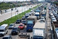 Thai people riding motorcycle and driving car on street while water flood or inundation road with vehicle busy jam traffic highway Royalty Free Stock Photo