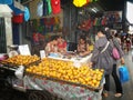 Thai people shopping for fruits and bracelet at the market