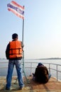 Thai people stand and sit wit movement wind and Flag pole of Thailand Royalty Free Stock Photo