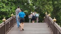 Thai people on wooden bridge towards other passersby in a park in Bang Krachao Bang Kachao