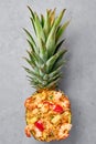 Thai Pineapple Fried Rice or Kao Pad Sapparod dish in pineapple bowl on gray backdrop. Thailand meal. Asian Food