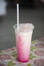 Thai pink tea with milk in plastic glass