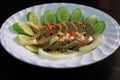 Thai pork sausage salad on white dish with cucumber,Spicy Vietnamese Pork Sausage Salad Royalty Free Stock Photo
