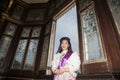 The lady in Middle Thai classical traditional dress suit posing indoor at old railway station building. Royalty Free Stock Photo