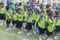The Thai primary school students in green shirts standing in line to march in the school field every morning. Pranburi, Thailand