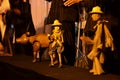 Thai professional puppeteer or Puppet master manipulate playing acting ancient puppets toy or antique marionette on stage show