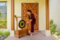 Thai restaurant waitress using the gong