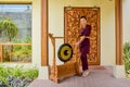 Thai restaurant waitress using the gong wit a smile