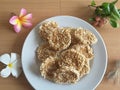 Thai rice biscuit on plate, flowers frangipani Royalty Free Stock Photo