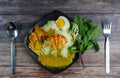 Thai rice noodles in grab curry sauce with vegetable and boiled eggs on wood table Royalty Free Stock Photo