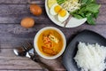 Thai rice noodles in grab curry sauce with vegetable and boiled eggs on wood table Royalty Free Stock Photo