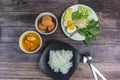 Thai rice noodles in grab curry sauce with vegetable and boiled eggs on wood table Royalty Free Stock Photo