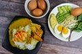 Thai rice noodles in grab curry sauce with vegetable and boiled eggs on wood table Royalty Free Stock Photo