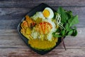 Thai rice noodles in grab curry sauce with vegetable and boiled eggs on wood table Royalty Free Stock Photo